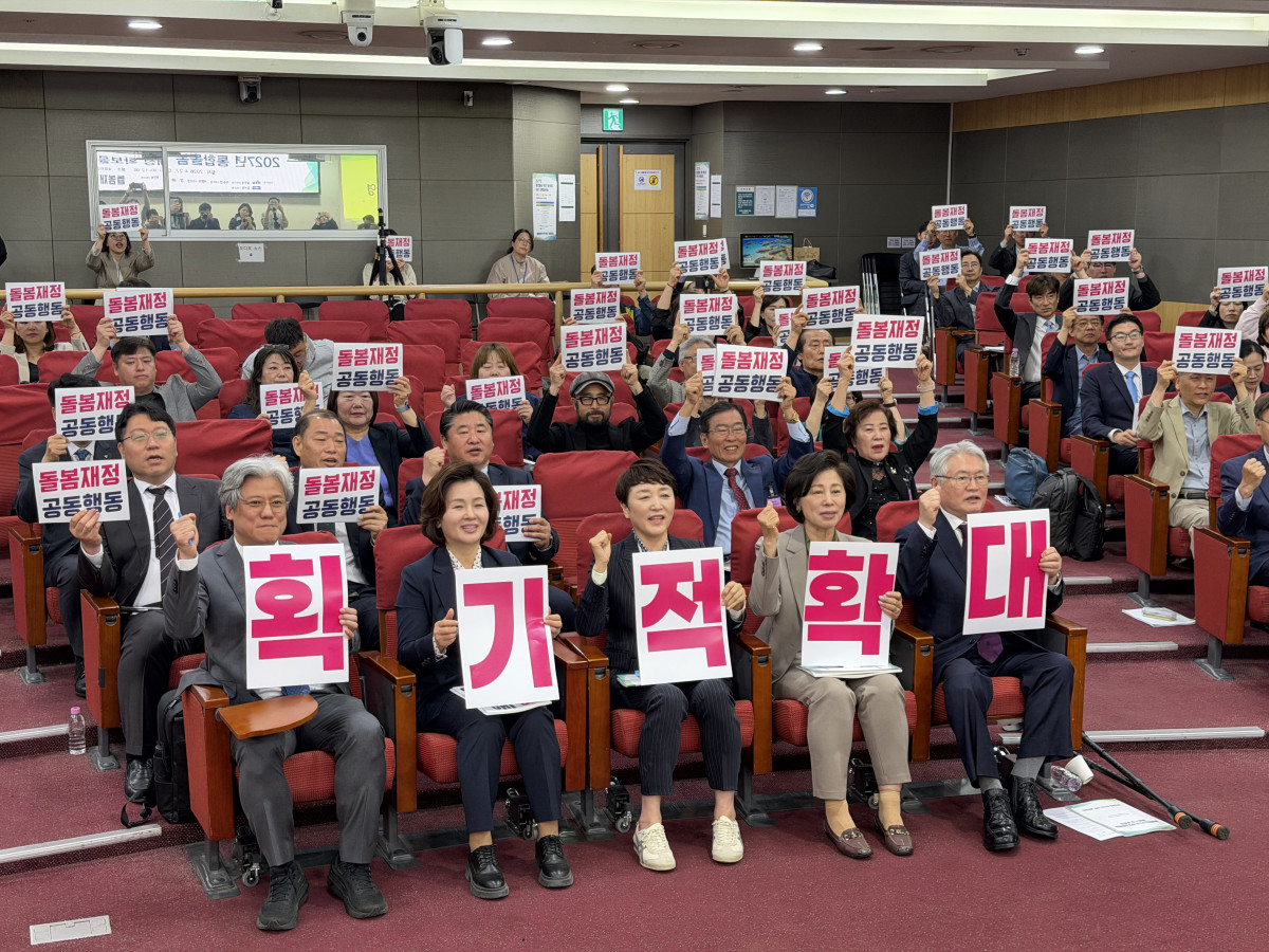 ▲‘2027년 통합돌봄 재정 확보를 위한 정책토론회’ 참석자들이 돌봄재정 확대를 촉구하는 팻말을 들고 기념촬영을 하고 있다. 앞줄 가운데에는 더불어민주당 남인순·이수진·전진숙 의원이 함께했다.(이준호 기자)