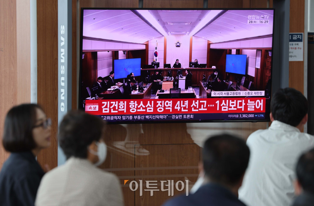 ▲28일 서울역 대합실에서 시민들이 통일교 금품 수수와 도이치모터스 주가조작, 명태균 무상 여론 조사 등의 혐의를 받는 김건희의 2심 공판 생중계를 지켜보고 있다. 법원은 징역 4년에 벌금 5000만원을 선고했다. 김예연 인턴기자 kimye@