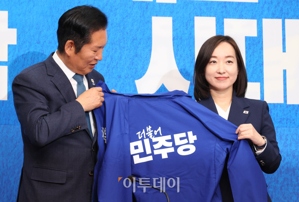 ▲전은수(오른쪽) 전 청와대 대변인이 29일 서울 여의도 국회에서 열린 민주당 인재영입식에서 정청래 당대표에게 파란 점퍼를 받고 있다. 고이란 기자 photoeran@
