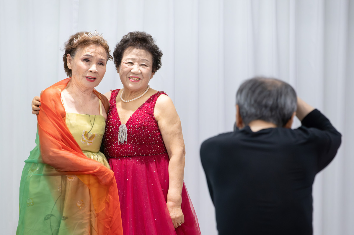 ▲한국시니어문화네트웍스가 12일 서울 H&C 평생교육원에서 연 ‘패션 모델 체험하기’ 행사에서 상계 불암산 대림아파트 경로당 어르신들이 드레스를 입고 기념 촬영을 하고 있다.(이준호 기자)