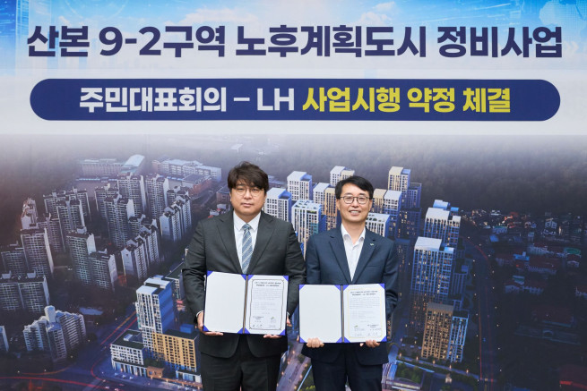 ▲강오순 LH 지역균형본부장(오른쪽)과 권성환 군포산본 9-2구역 주민대표회의 위원장이 15일 LH 경기남부지역본부에서 협약 기념사진을 촬영하고 있다. (사진제공=한국토지주택공사)