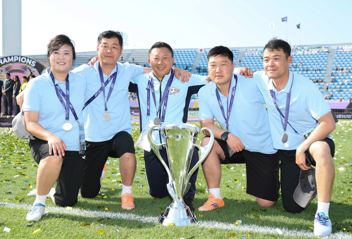 ▲내고향여자축구단의 리유일 감독(중앙)을 비롯한 코치진이 우승 기념촬영을 하는 모습. (뉴시스)