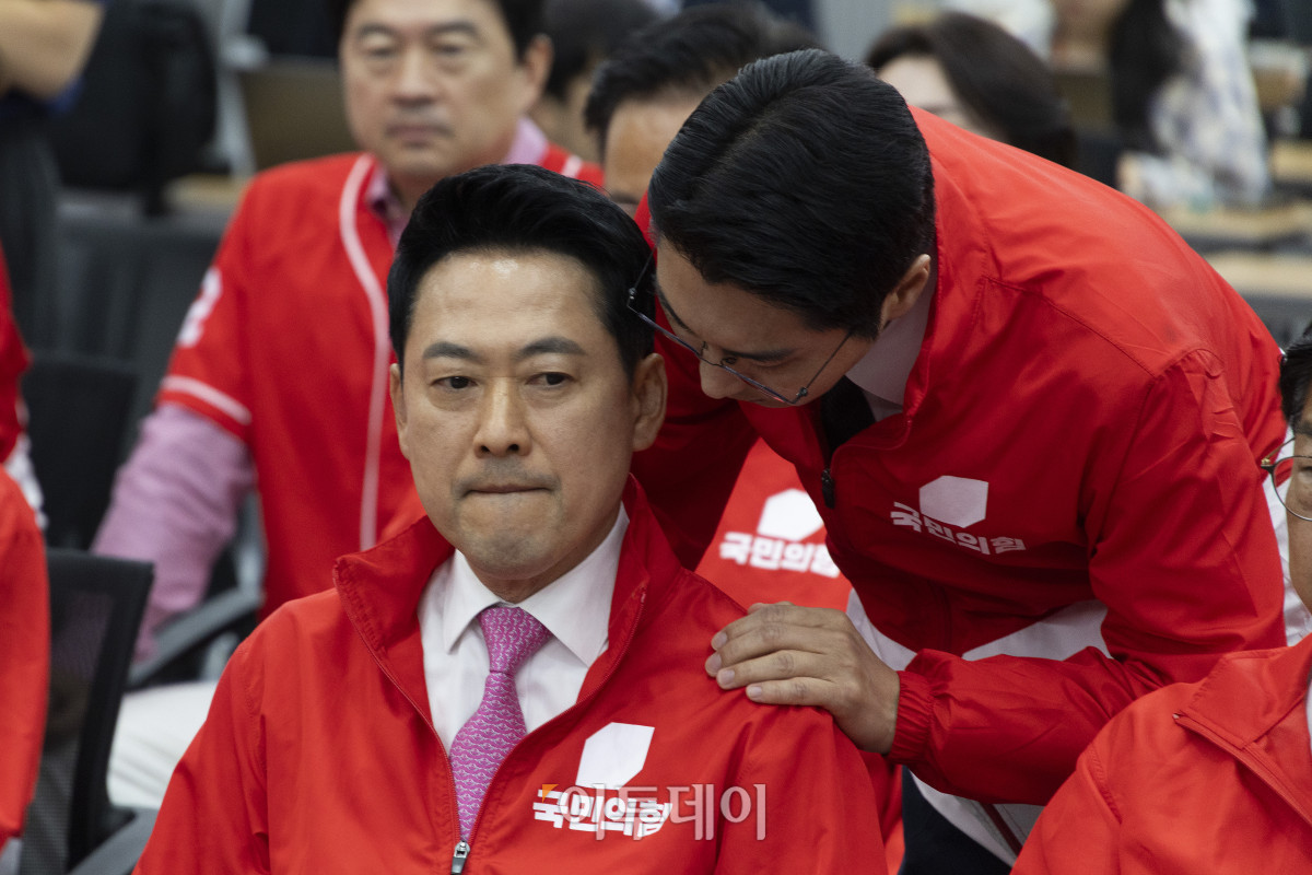 ▲장동혁(왼쪽) 국민의힘 대표가 3일 서울 여의도 중앙당사에서 6·3 지방선거와 재보궐선거 출구조사 결과 방송을 보며 박준태 비서실장의 보고를 받고 있다. 국회사진기자단