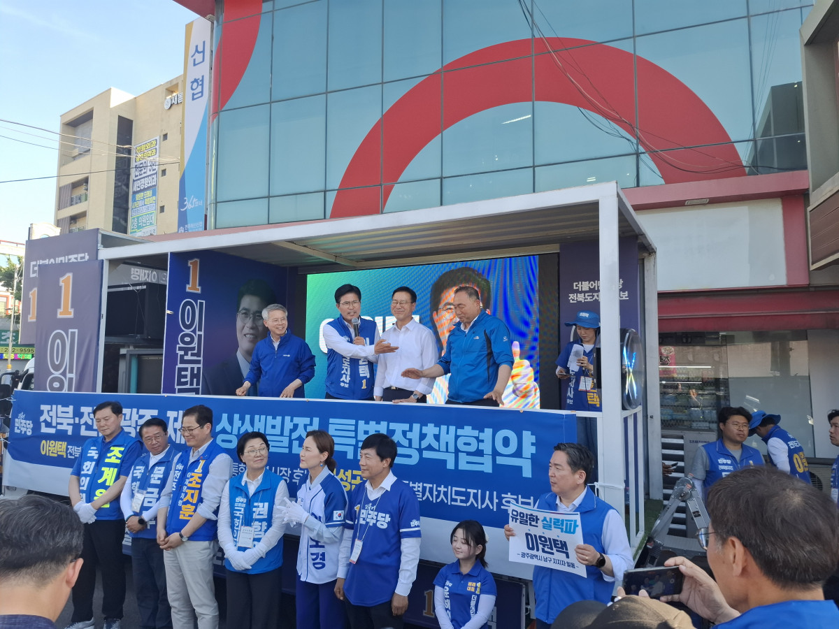▲이원택 더불어민주당 전북도지사 후보가 전주 모래내시장에서 더불어민주당 관계자들과 함께 한 표를 호소하고 있다. (사진제공=조경환 기자)