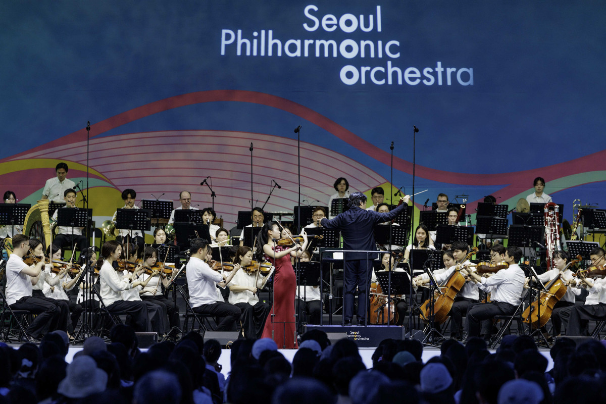 ▲한국경제인협회가 창립 65주년을 맞아 서울시립교향악단과 공동으로 개최한 '2026 서울시향 강변음악회'가 13일 저녁 서울 여의도 한강공원에서 열린 가운데, 지휘자 김선욱의 지휘 아래 바이올리니스트 김서현이 서울시향과 함께 협연 무대를 선보이고 있다. (한경협)