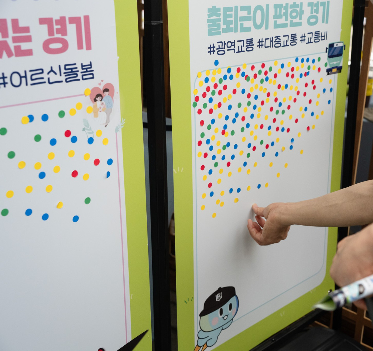 ▲경기도가 3일부터 5일까지 수원KT위즈파크에서 진행한 현장 참여형 여론조사에서 한 참여자가 '출퇴근이 편한 경기' 정책 투표판에 스티커를 붙이고 있다. (경기도)