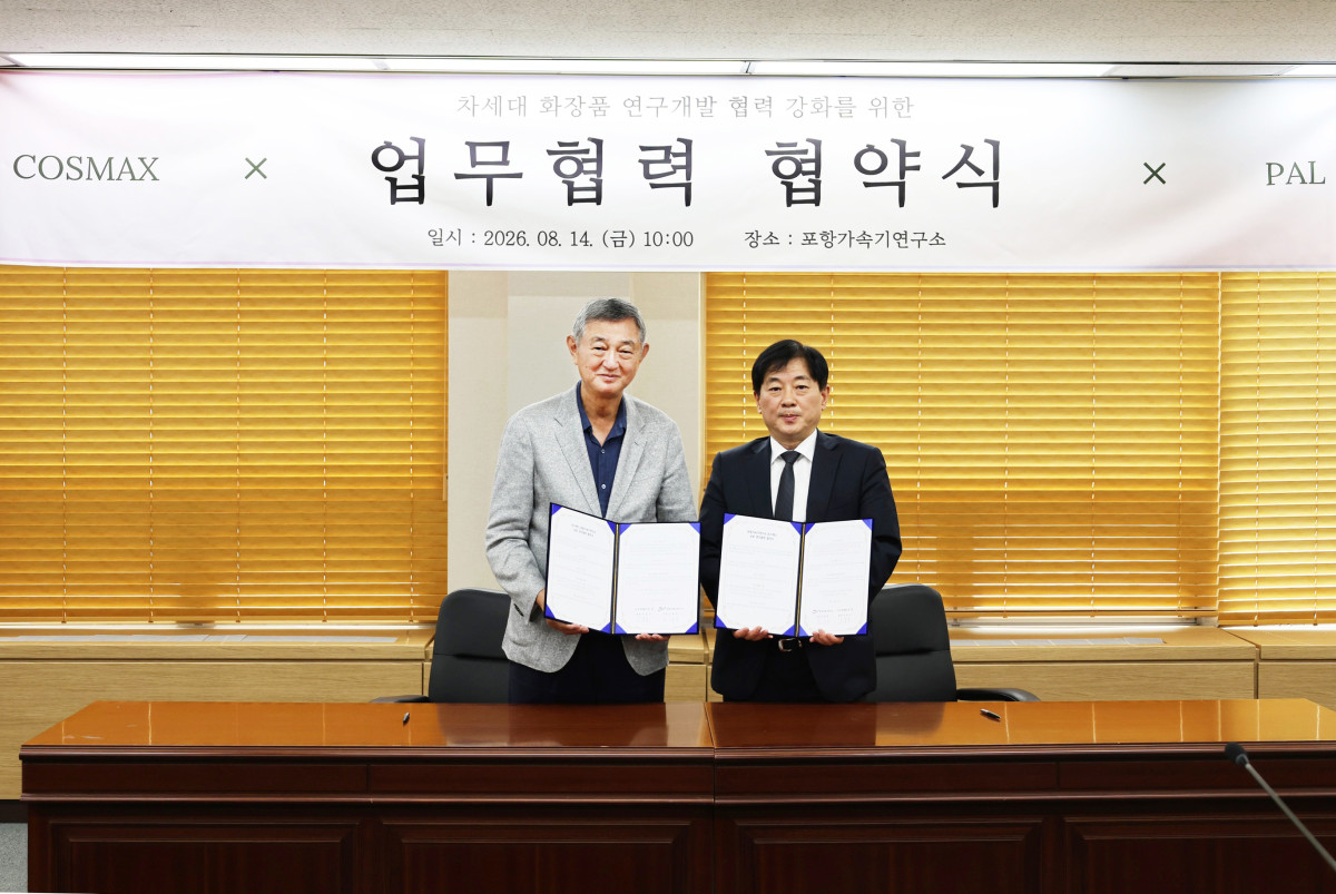 ▲이경수(사진 왼쪽) 코스맥스그룹 회장과 김재영 포항가속기연구소 소장이 14일 포항가속기연구소에서 열린 MOU 체결식에서 기념촬영을 하고 있다. (사진제공=코스맥스)