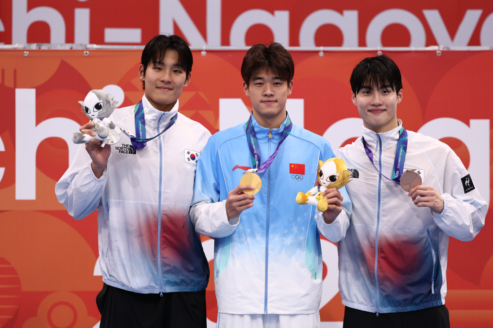 ▲20일 도쿄 아쿠아틱스 센터에서 열린 2026 아이치·나고야 아시안게임 수영 남자 100m 자유형 결승에서 은메달과 동메달을 획득한 한국 김영범, 황선우가 기념촬영하고 있다. 가운데는 금메달을 차지한 중국 판잔러. (연합뉴스)