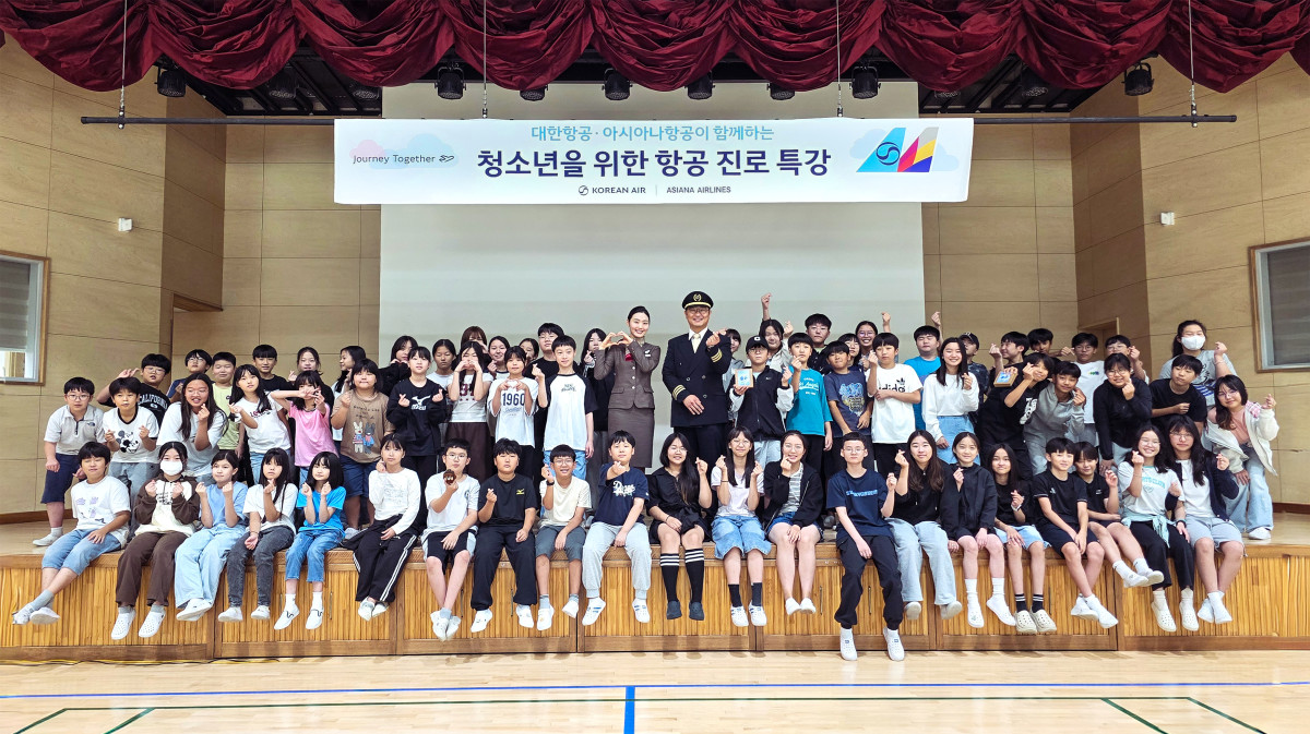 ▲29일 항공 진로 특강에 참가한 학생들이 대한항공 운항승무원, 아시아나항공 객실승무원 멘토와 기념사진을 촬영하는 모습. (사진=대한항공)
