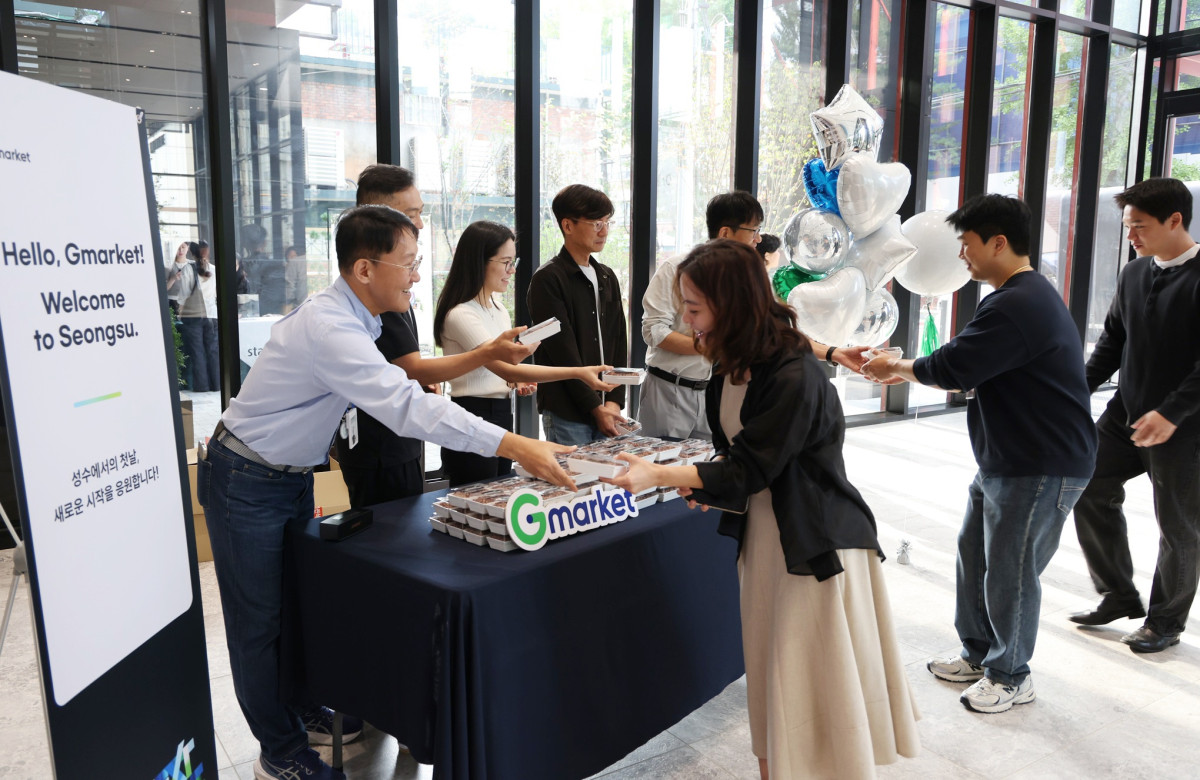 ▲12일 성수동 신사옥 출근 첫 날, G마켓 리더들이 출근하는 임직원들에게 떡을 나눠주며 새로운 출발을 함께 축하하는 모습 (사진제공=G마켓)
