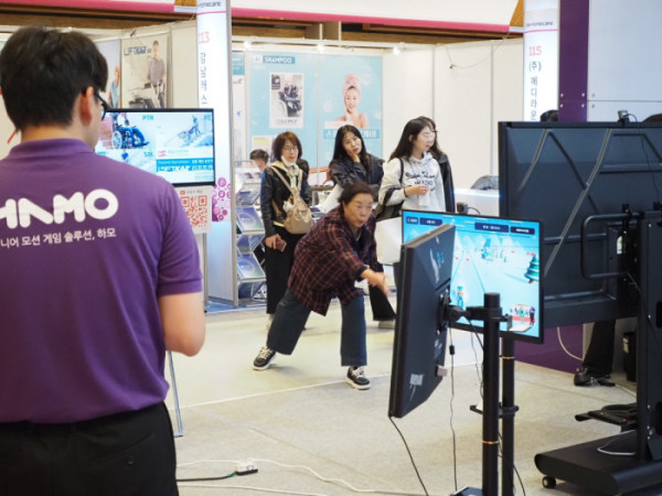 ▲21일 서울 코엑스에서 열린 ‘2026 홈케어·재활·복지 전시회'에서 한 관람객이 몸동작으로 화면 속 게임을 조작하는 시니어 운동 게임 '하모'를 체험하고 있다.(이준호 기자)